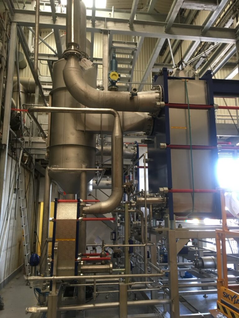 Stainless steel process pipework installed around food processing equipment