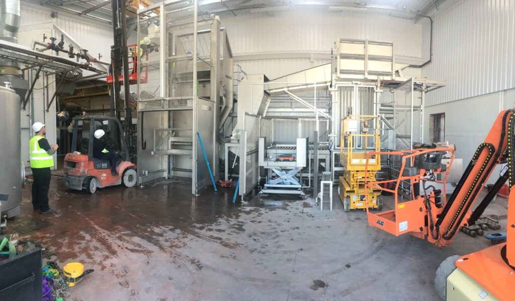 Installation of stainless steel pallet tipping equipment for food processing