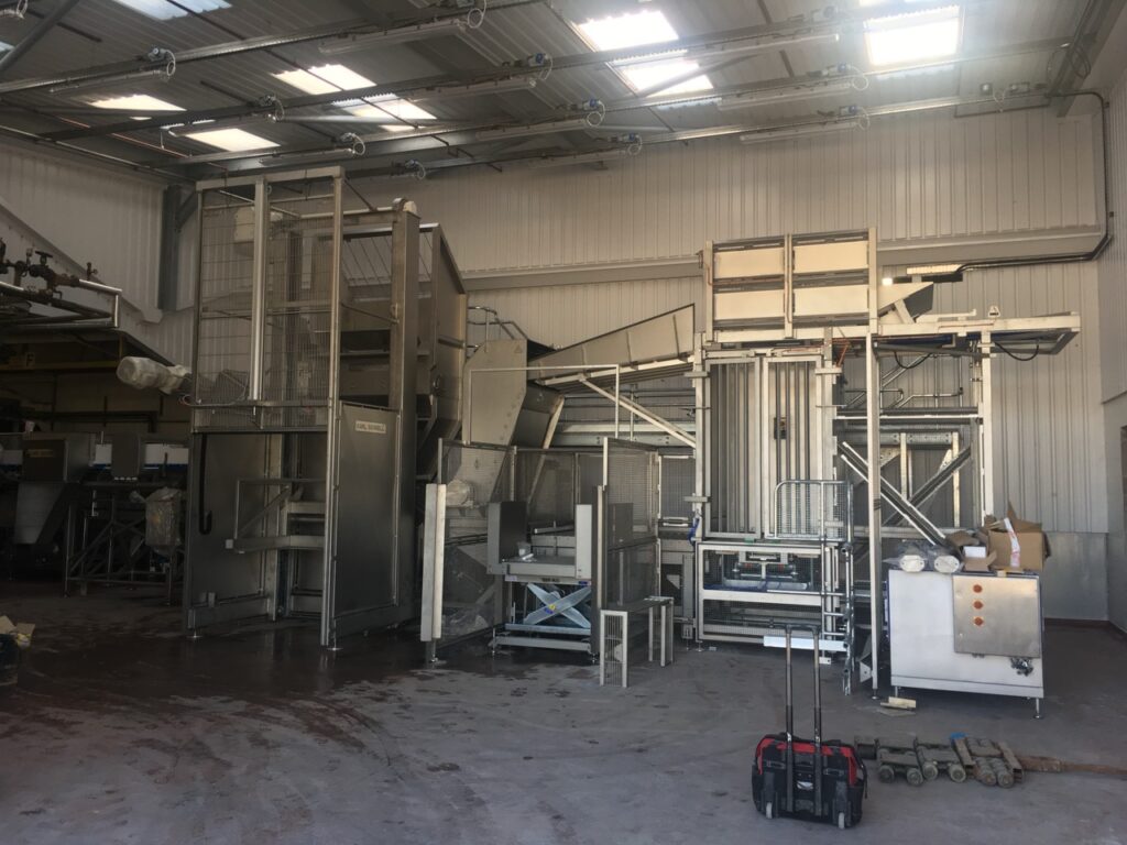 Stainless steel pallet tipper and processing equipment installation